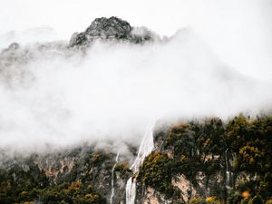 Preview wallpaper mountains, rocks, waterfall, trees, fog, clouds