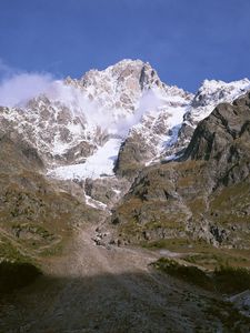 Preview wallpaper mountains, shadow, top, stones, grass, trees, clouds, fir-tree