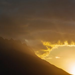Preview wallpaper mountains, slope, clouds, rays, sun