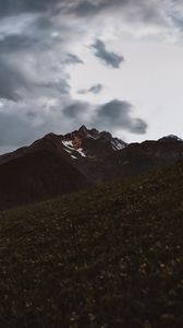 Preview wallpaper mountains, slope, rocks, grass, lights, sky