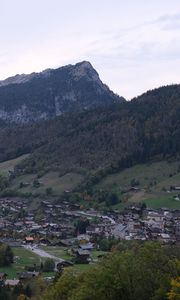 Preview wallpaper mountains, slope, trees, houses, village, valley