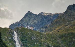 Preview wallpaper mountains, slope, waterfall, house, grass, nature