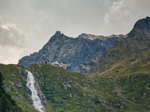 Preview wallpaper mountains, slope, waterfall, house, grass, nature