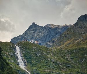 Preview wallpaper mountains, slope, waterfall, house, grass, nature