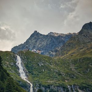 Preview wallpaper mountains, slope, waterfall, house, grass, nature