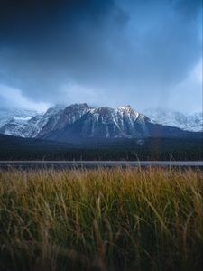 Preview wallpaper mountains, snowy, grass, road