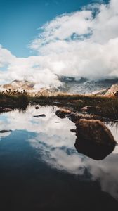 Preview wallpaper mountains, stones, grass, clouds, lake