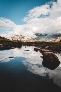 Preview wallpaper mountains, stones, grass, clouds, lake