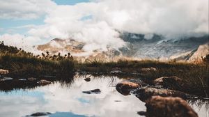 Preview wallpaper mountains, stones, grass, clouds, lake