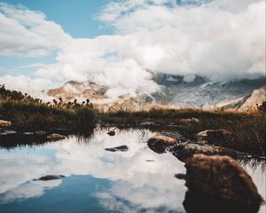 Preview wallpaper mountains, stones, grass, clouds, lake