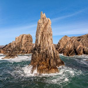 Preview wallpaper mountains, stones, rocks, sea, sea foam, nature, sky