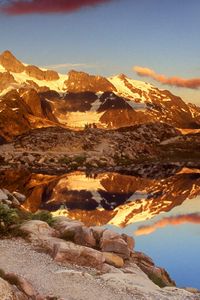 Preview wallpaper mountains, stones, sky, shades, water, reflection, clouds