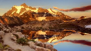 Preview wallpaper mountains, stones, sky, shades, water, reflection, clouds