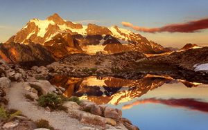 Preview wallpaper mountains, stones, sky, shades, water, reflection, clouds