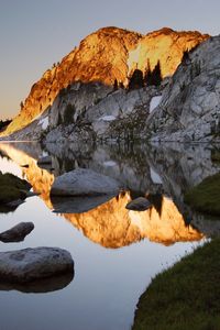 Preview wallpaper mountains, stones, water, shades, rocks, coast