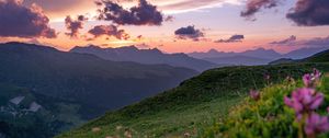 Preview wallpaper mountains, sunset, landscape, slopes, grass, flowers