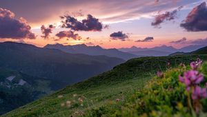 Preview wallpaper mountains, sunset, landscape, slopes, grass, flowers