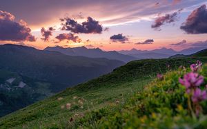 Preview wallpaper mountains, sunset, landscape, slopes, grass, flowers