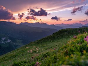 Preview wallpaper mountains, sunset, landscape, slopes, grass, flowers