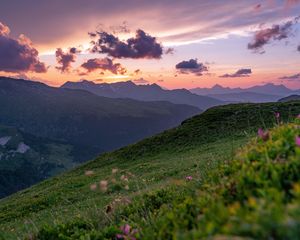 Preview wallpaper mountains, sunset, landscape, slopes, grass, flowers