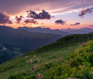 Preview wallpaper mountains, sunset, landscape, slopes, grass, flowers