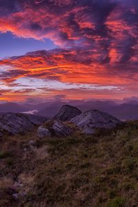 Preview wallpaper mountains, sunset, stones, grass, clouds, landscape