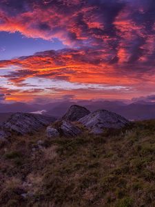 Preview wallpaper mountains, sunset, stones, grass, clouds, landscape