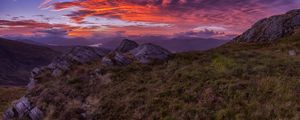 Preview wallpaper mountains, sunset, stones, grass, clouds, landscape