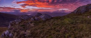 Preview wallpaper mountains, sunset, stones, grass, clouds, landscape