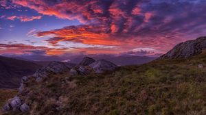 Preview wallpaper mountains, sunset, stones, grass, clouds, landscape