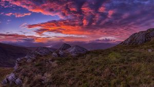 Preview wallpaper mountains, sunset, stones, grass, clouds, landscape