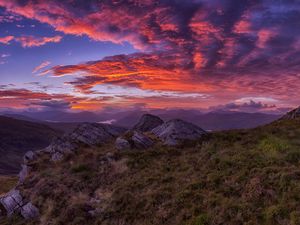 Preview wallpaper mountains, sunset, stones, grass, clouds, landscape