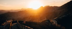 Preview wallpaper mountains, sunset, wall, building, people