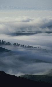 Preview wallpaper mountains, trees, fog, haze, gloom, clouds