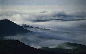 Preview wallpaper mountains, trees, fog, haze, gloom, clouds