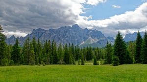 Preview wallpaper mountains, trees, grass, clouds