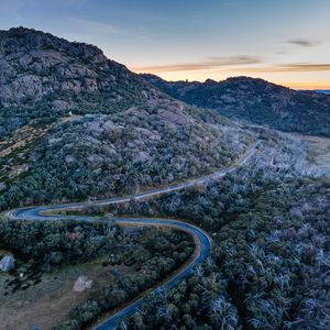 Preview wallpaper mountains, trees, road, sunset