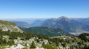 Preview wallpaper mountains, trees, stones, lake, horizon, view, landscape