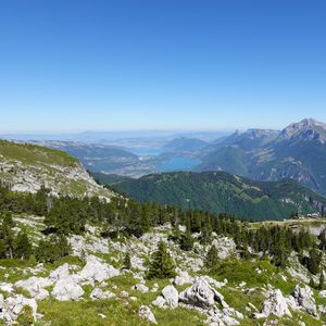 Preview wallpaper mountains, trees, stones, lake, horizon, view, landscape