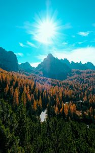 Preview wallpaper mountains, trees, sun, rays, autumn, aerial view