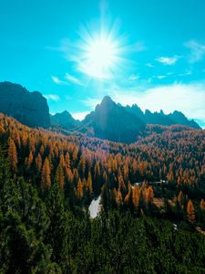 Preview wallpaper mountains, trees, sun, rays, autumn, aerial view