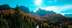 Preview wallpaper mountains, trees, sun, rays, autumn, aerial view