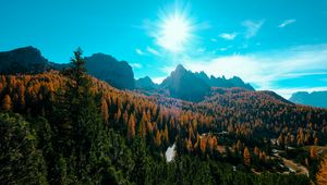 Preview wallpaper mountains, trees, sun, rays, autumn, aerial view