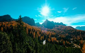 Preview wallpaper mountains, trees, sun, rays, autumn, aerial view