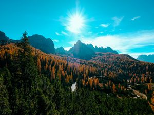 Preview wallpaper mountains, trees, sun, rays, autumn, aerial view