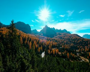 Preview wallpaper mountains, trees, sun, rays, autumn, aerial view