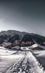 Preview wallpaper mountains, village, winter, snow, path