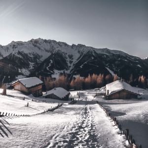 Preview wallpaper mountains, village, winter, snow, path