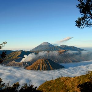 Preview wallpaper mountains, volcanoes, fog, clouds, height, craters, sky