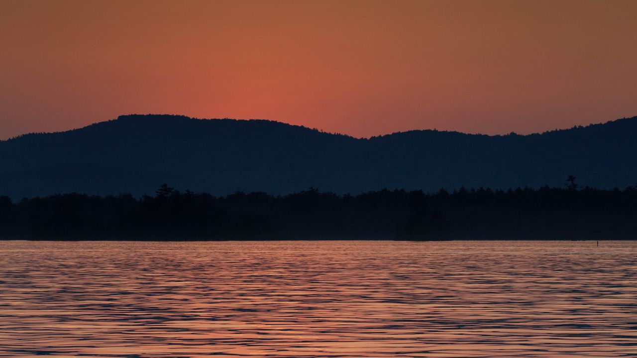 Wallpaper mountains, water, waves, glare, sunset